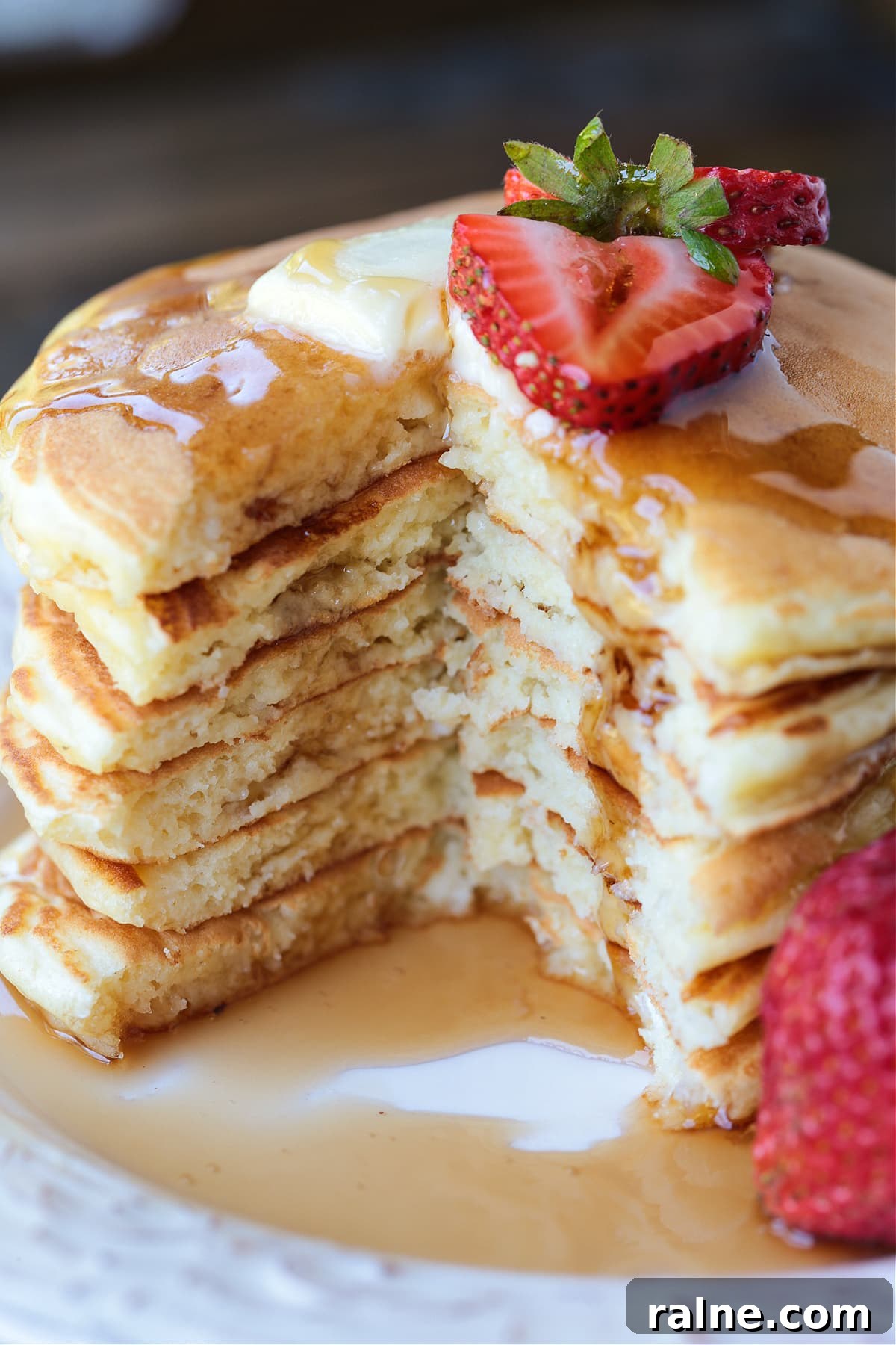 Cottage Cheese Pancakes are a tasty way to get more protein into your breakfast! Fluffy, protein packed pancakes that melt in your mouth! cottage cheese pancakes stacked on a plate with a wedge cut out