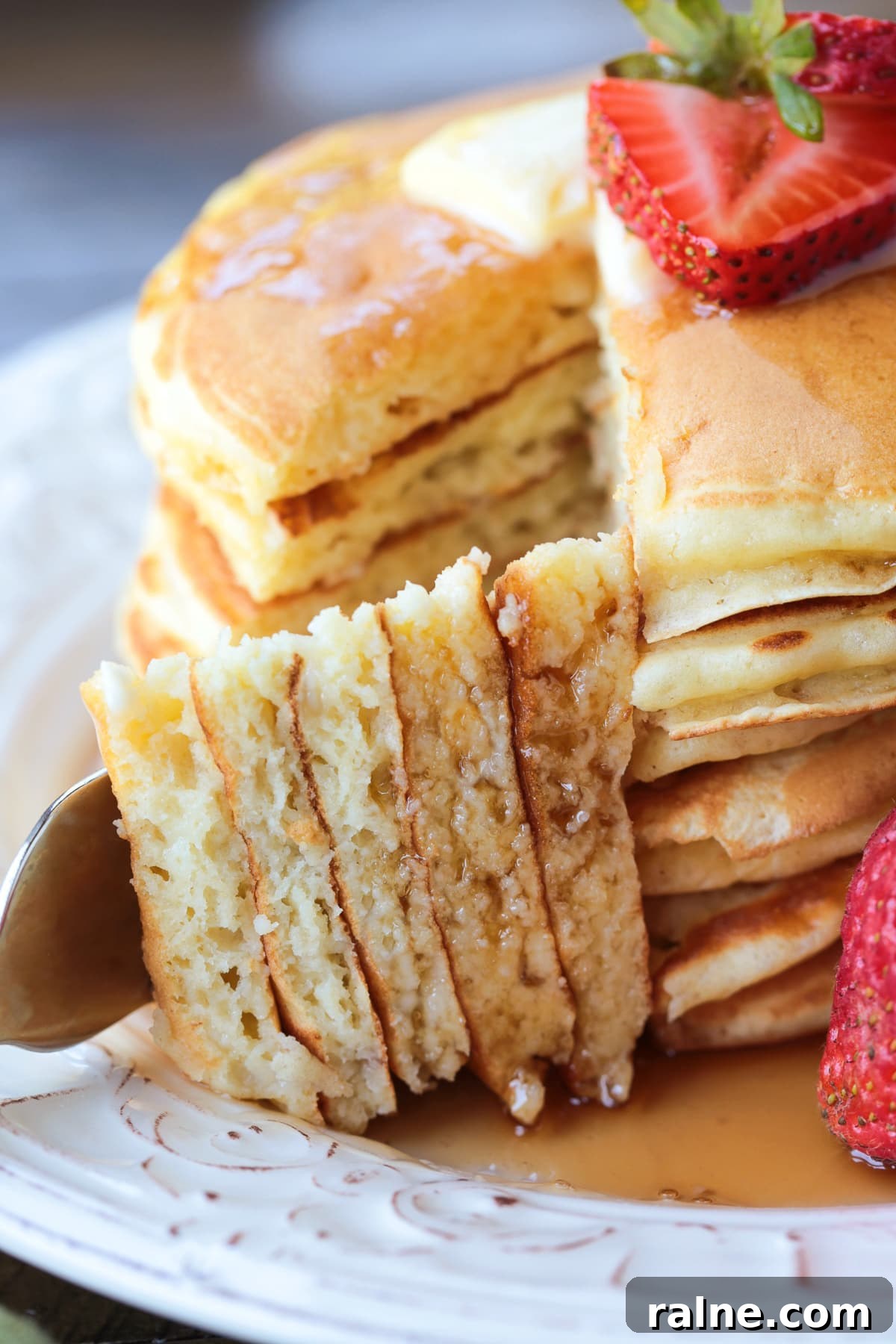 Cottage Cheese Pancakes are a tasty way to get more protein into your breakfast! Fluffy, protein packed pancakes that melt in your mouth! a fork holding a wedge of pancakes with pancake stack in background