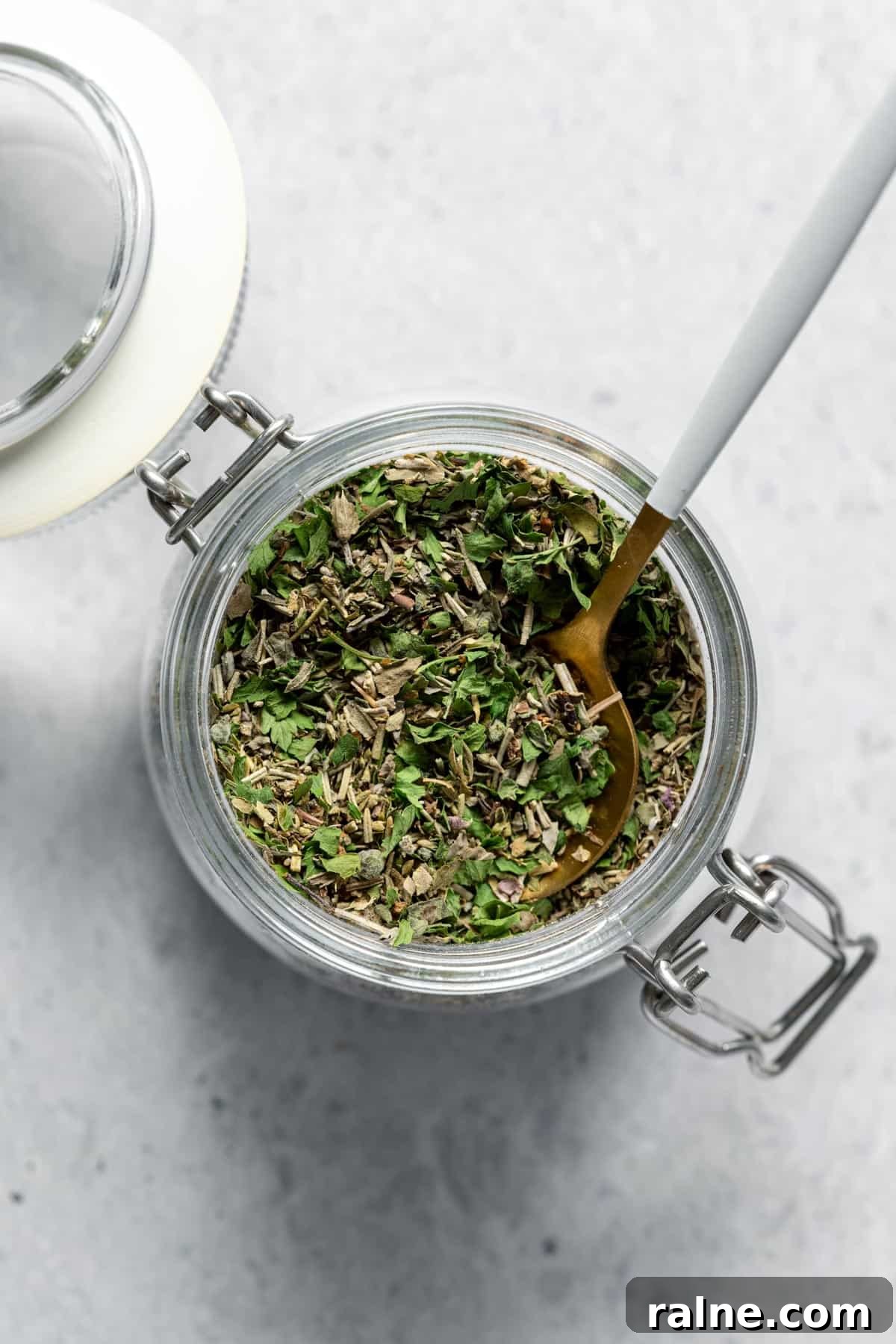 DIY Italian Seasoning jar of Italian seasoning with spoon