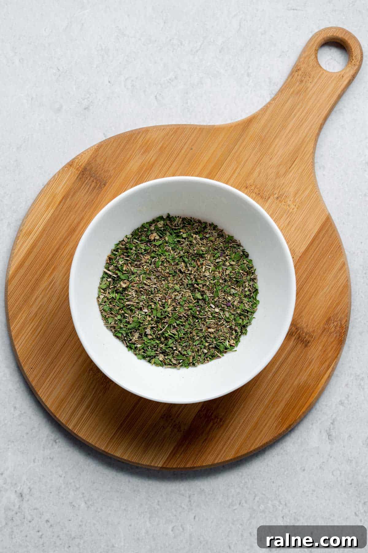 Homemade Italian Seasoning white bowl filled with dried herbs