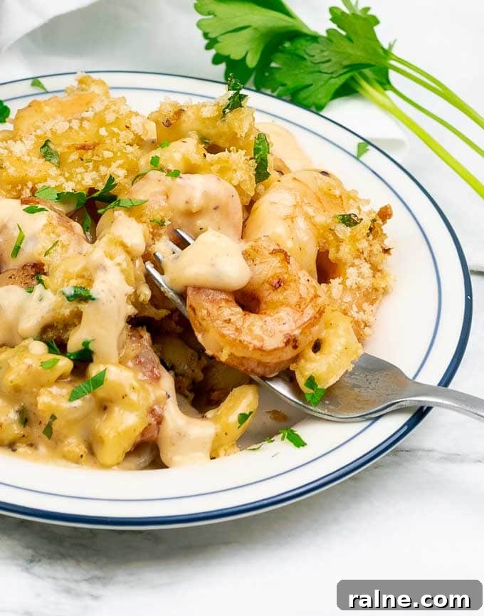 Creamy Baked Shrimp Mac and Cheese Casserole 2 Baked Shrimp Macaroni and Cheese on a white plate with fork tines