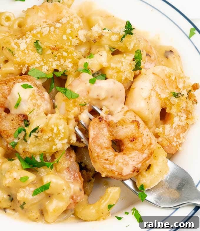 Creamy Baked Shrimp Mac and Cheese Casserole 7 close up of Baked Shrimp Macaroni and Cheese with fork tines