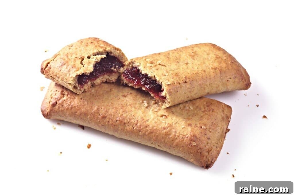 Nutri-Grain Bars: A Dietitian’s Honest Review of Nutrition 3 Two cereal bars with one broken in half on a white background.