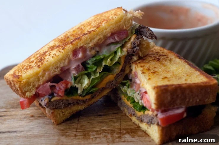 Texas Toast Griddle Burgers sliced in half on a wooden board.