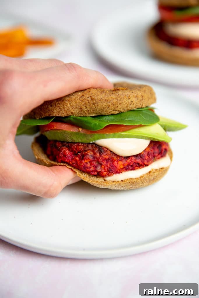 A hand grabbing a veggie burger.