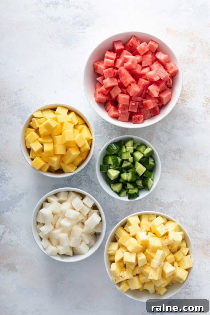 Authentic Mexican Fruit Cups (Vasos de Fruta) — Street Snack Recipe 4 Small bowls of diced fruit, watermelon, mango, cucumber, jicama and pineapple.