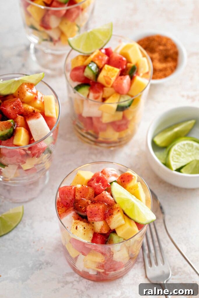 Authentic Mexican Fruit Cups (Vasos de Fruta) — Street Snack Recipe 8 Cups filled with chopped fruit pieces seasoned with tajin and chamoy sauce