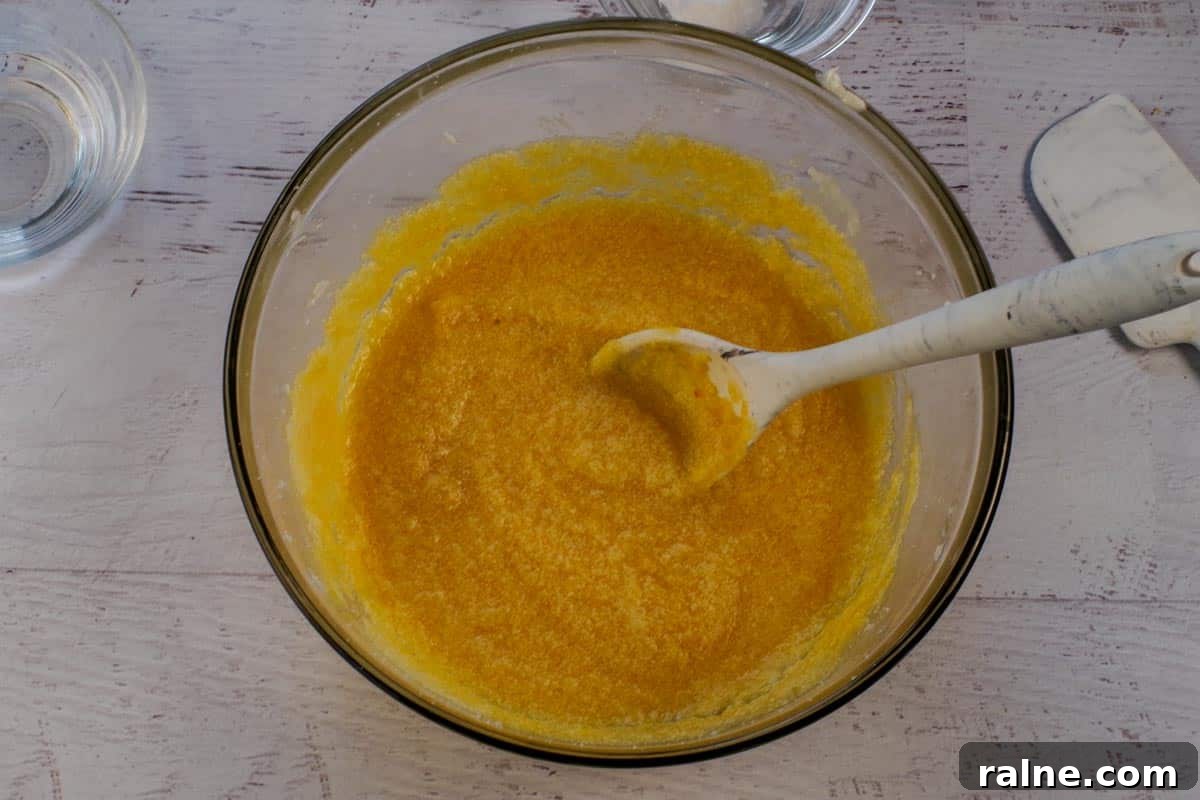 Dairy-Free Pumpkin Walnut Bread Recipe 7 Pumpkin stirred into vegetable shortening mixture in large glass bowl.