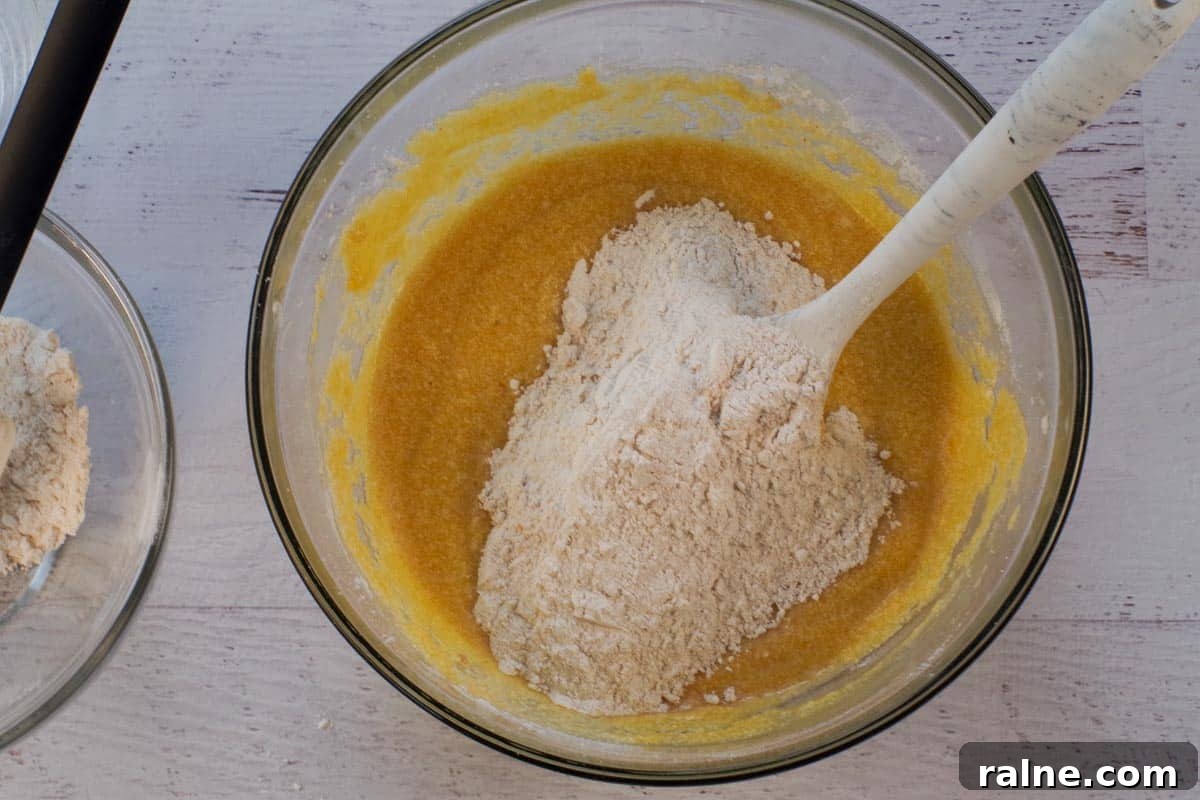 Dairy-Free Pumpkin Walnut Bread Recipe 10 Dry ingredients added to batter alternately with water in large glass bowl.