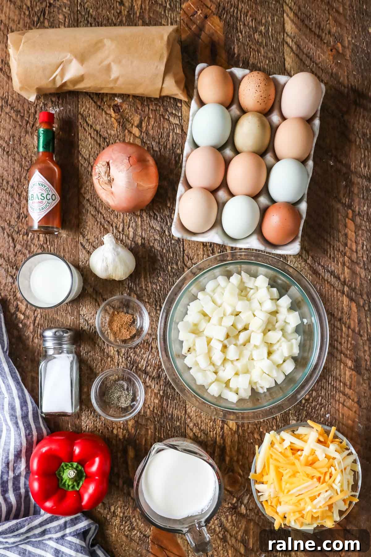 Hearty Breakfast Casserole Recipe for Busy Mornings 4 Overhead view of ingredients including eggs, hash browns, tabasco, and more.
