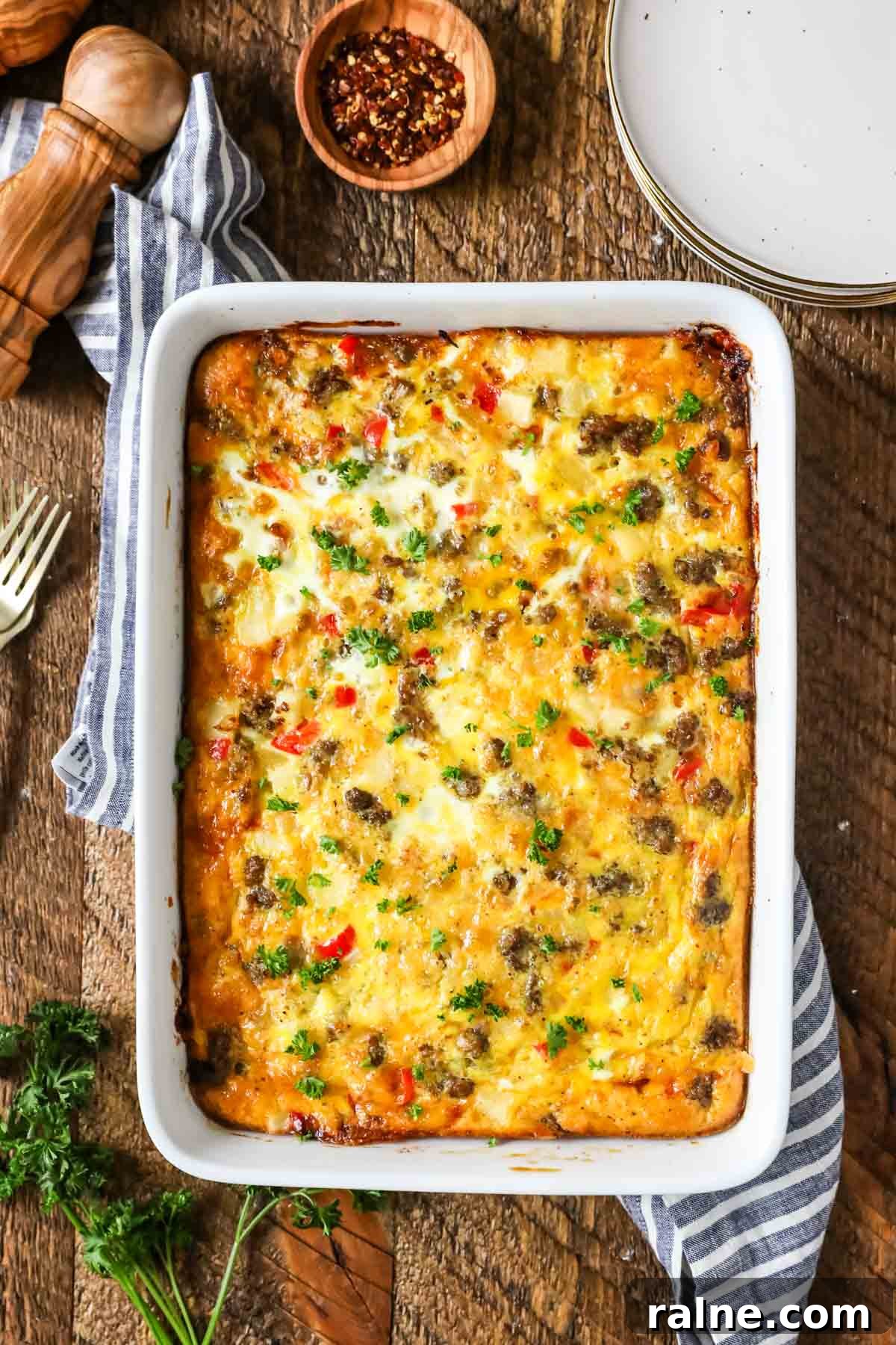 Hearty Breakfast Casserole Recipe for Busy Mornings 7 Overhead view of a casserole made with eggs, peppers, sausage, and more.