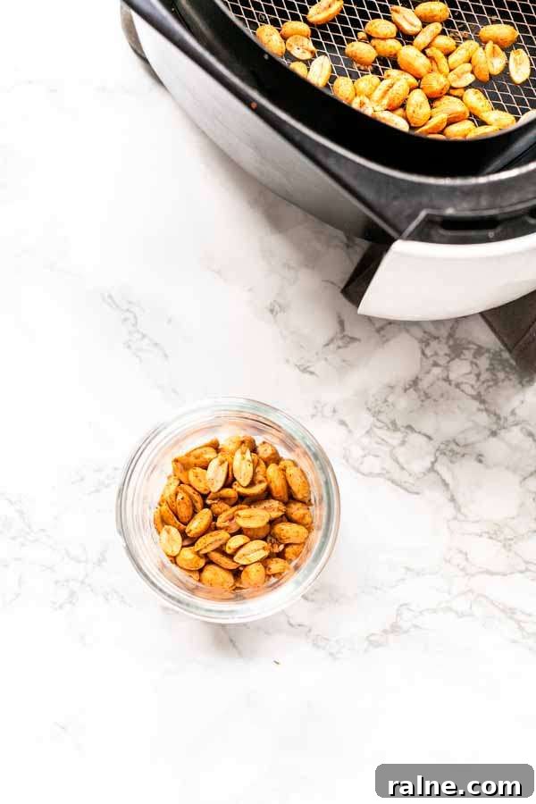 Crispy Homemade Air-Fried Peanuts Recipe 6 Air Fryer roasted peanuts in a glass jar. Ready to be served as a snack or use in your recipes. They can also be storer for a long time.