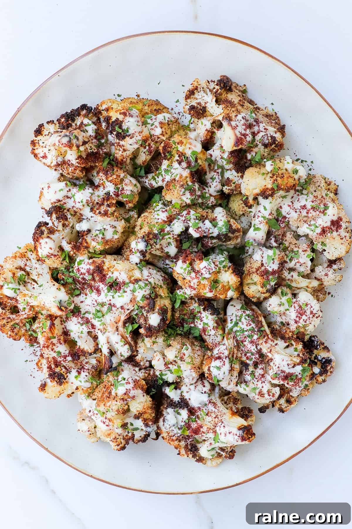 Sumac-Roasted Cauliflower with Creamy Tahini Sauce 3 Sumac cauliflower with tahini sauce drizzled on top.