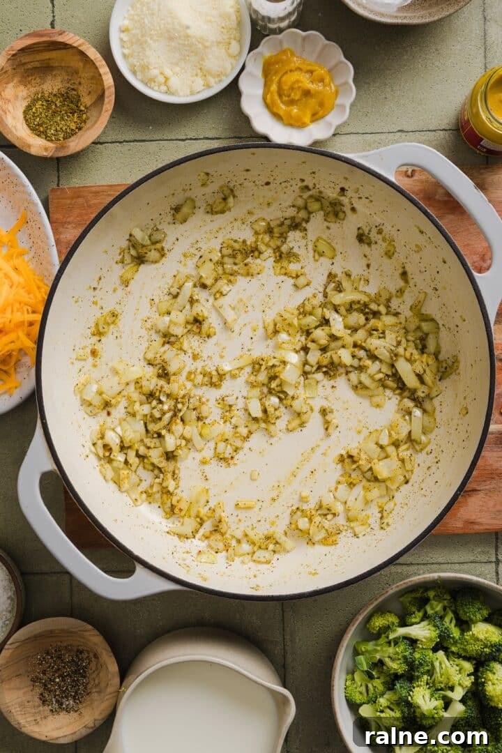 Creamy Broccoli Cheddar Orzo Bake with Parmesan Crust 4 Onions and seasonings cooked in a braiser pan.
