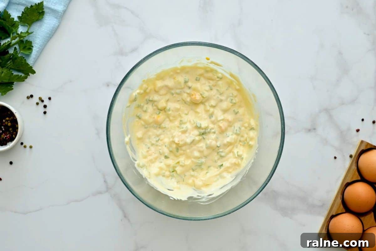 Mayonnaise mixed with diced hard-boiled eggs, minced onions, and minced celery.