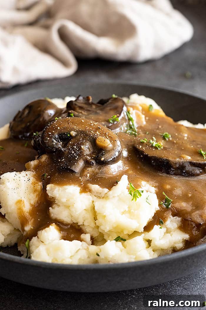 Creamy Mushroom Gravy Recipe for Roasts and Mashed Potatoes 6 Close up of gravy over mashed potatoes.