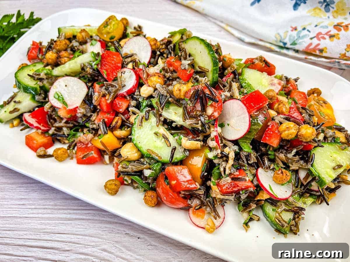 23 Make-Ahead Salads That Stay Fresh in the Fridge and Lunch Bag 11 Wild rice salad served on a white rectangular plate.
