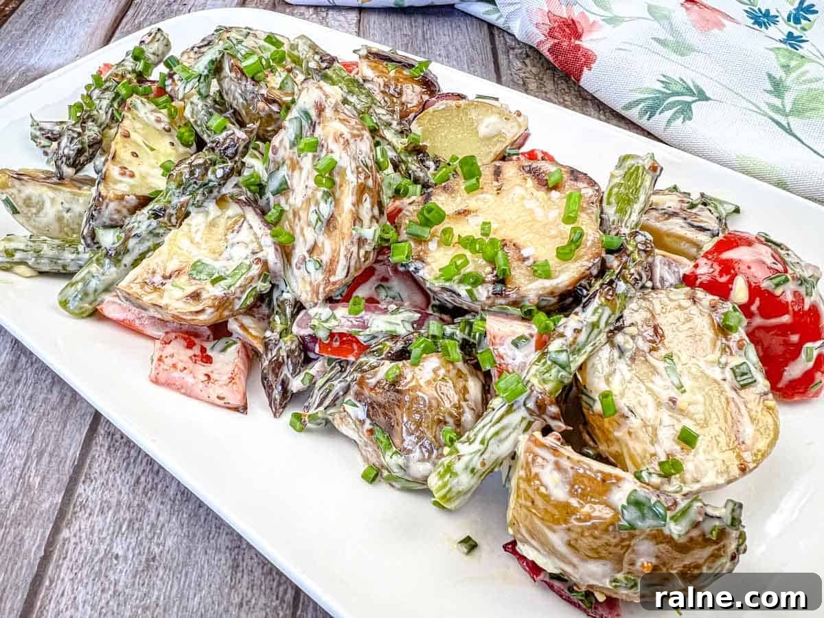 23 Make-Ahead Salads That Stay Fresh in the Fridge and Lunch Bag 15 Close-up shot of Grilled Asparagus and Potato Salad on a white plate.
