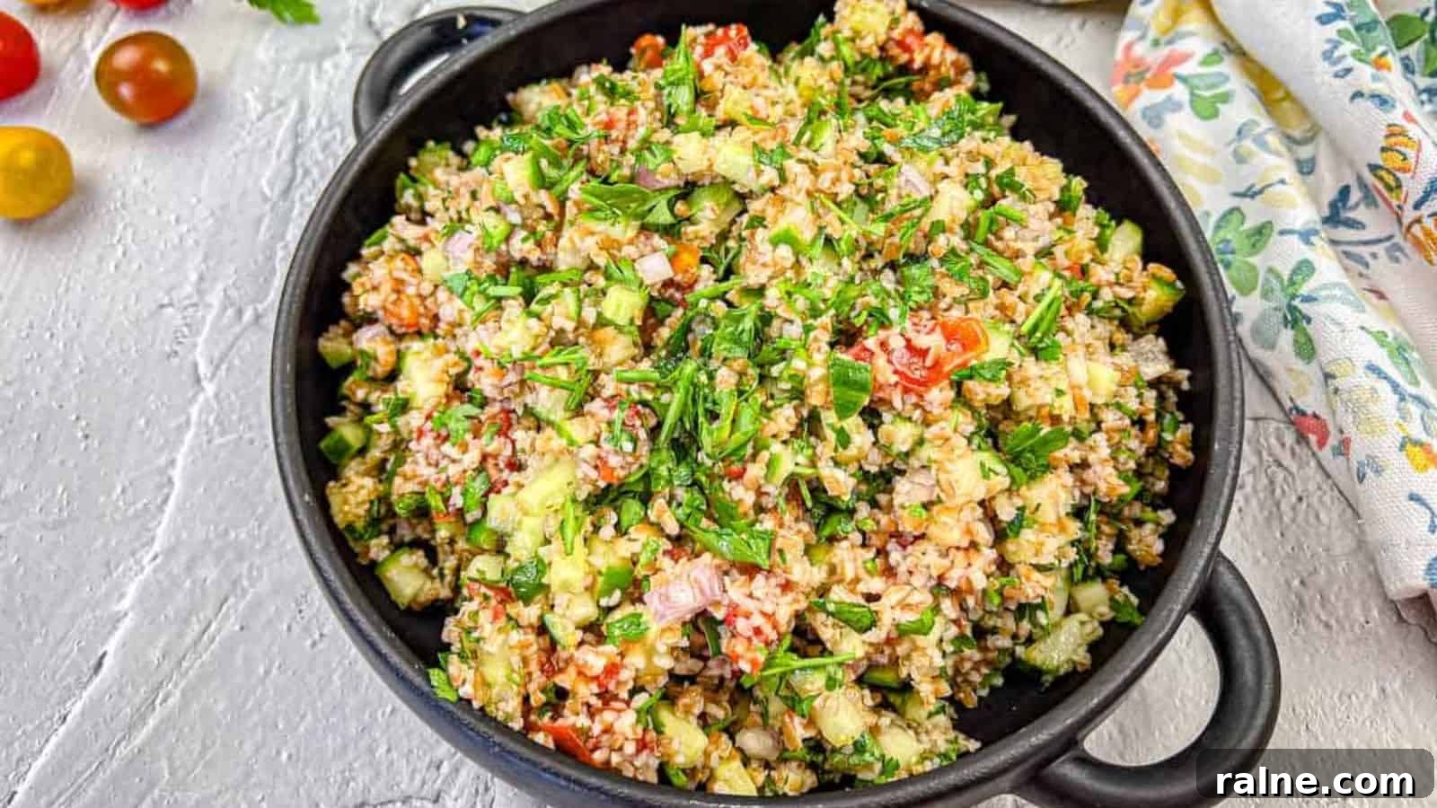 23 Make-Ahead Salads That Stay Fresh in the Fridge and Lunch Bag 18 A black bowl filled with tabbouleh salad with smoked tomatoes.