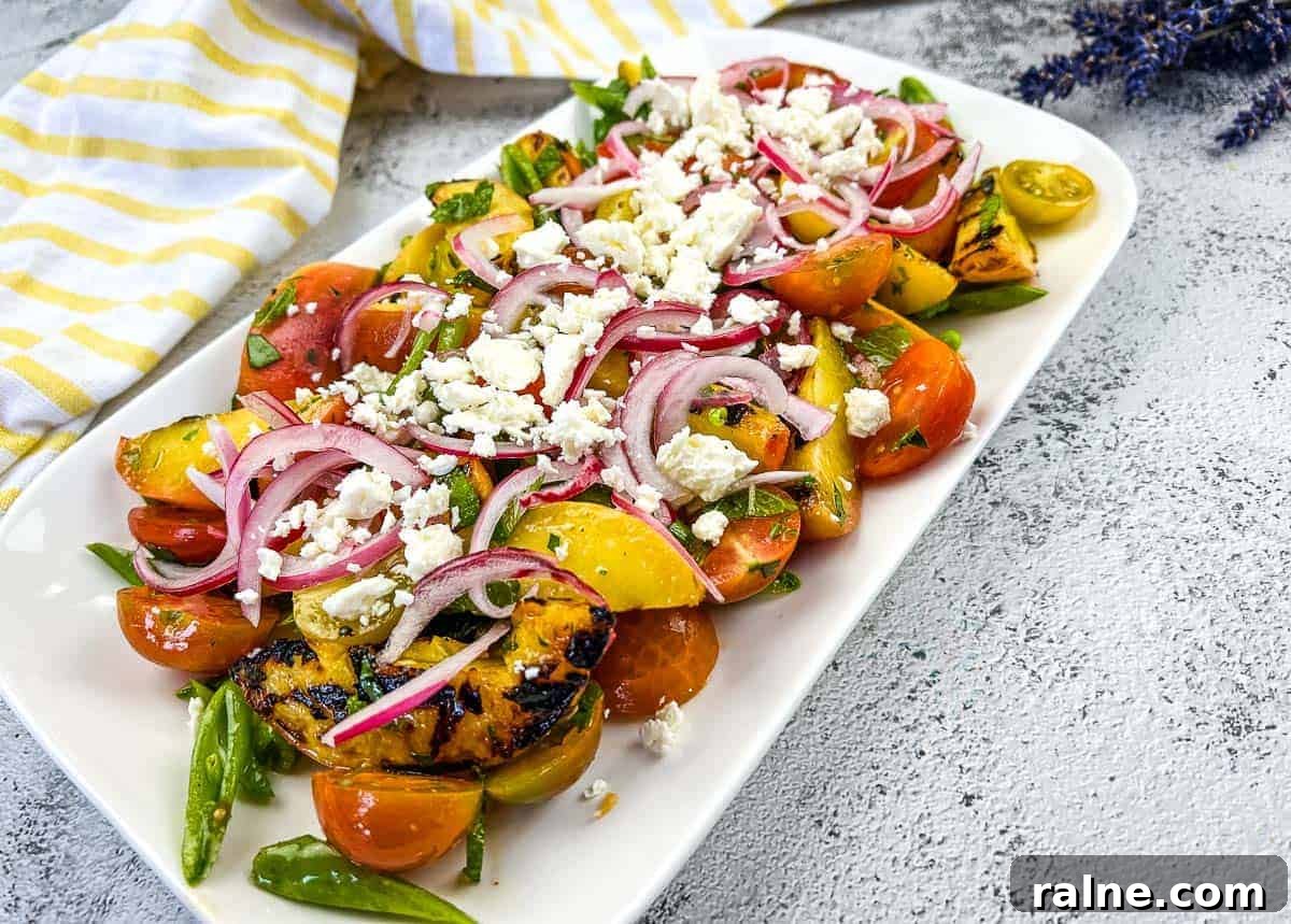 23 Make-Ahead Salads That Stay Fresh in the Fridge and Lunch Bag 21 A plate with Grilled Peach Salad with Tomatoes.