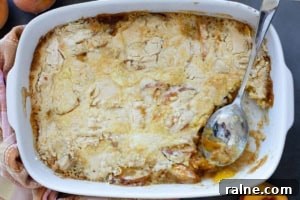 Cooked peach dump cake with a portion taken out.