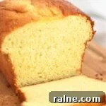 gluten free brioche loaf with a few slices cut on a wooden cutting board