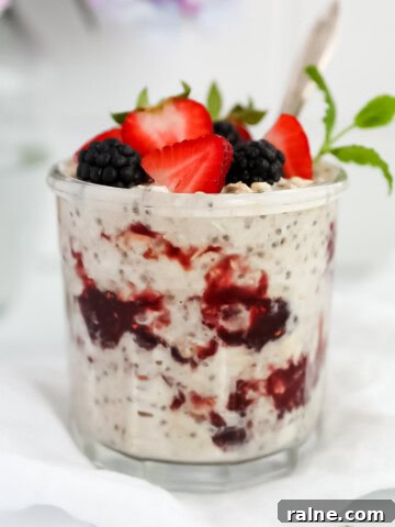 Peanut butter overnight oats in a jar with fresh fruit and a spoon.