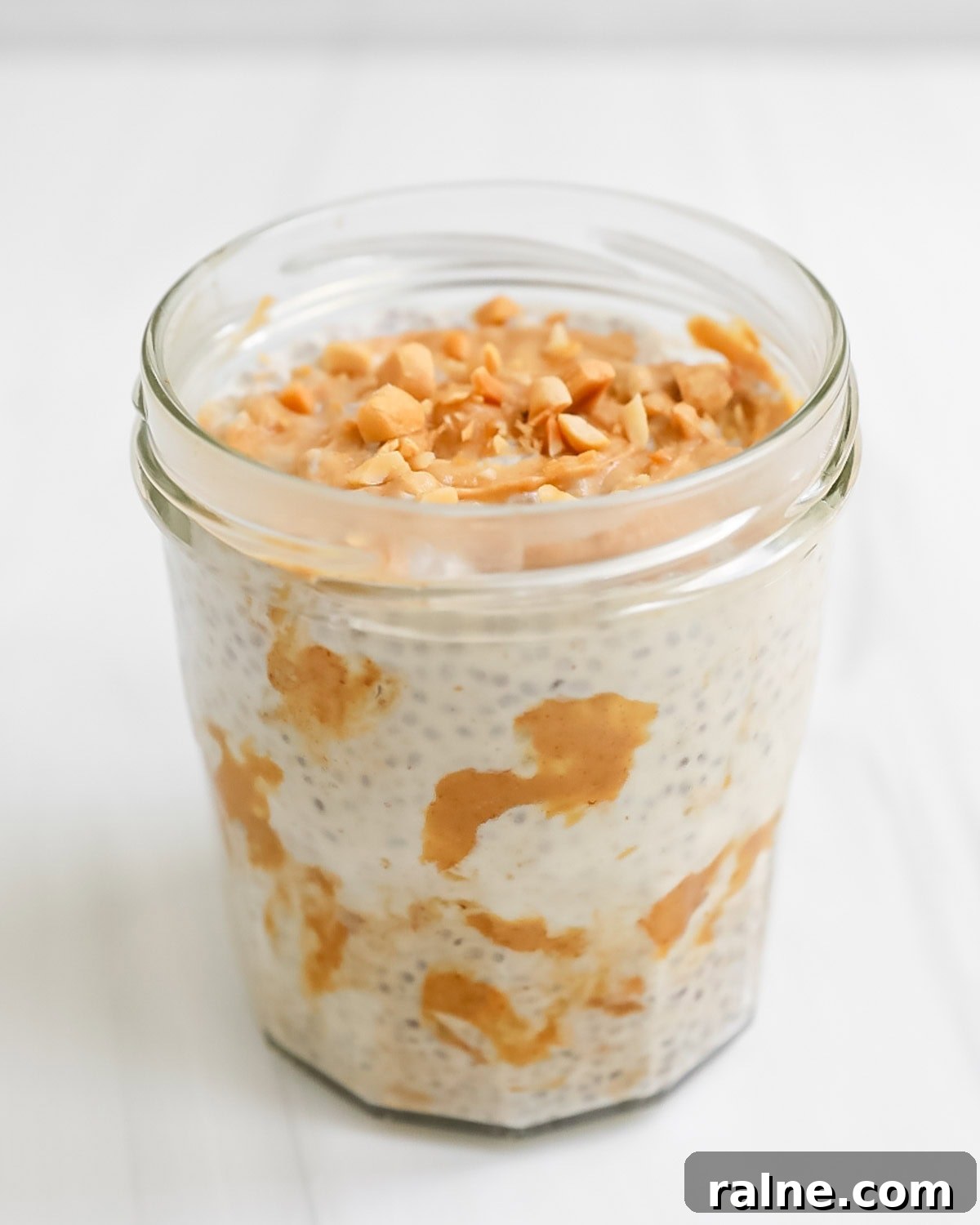 Chia seed pudding with chopped peanuts on top in a cup.