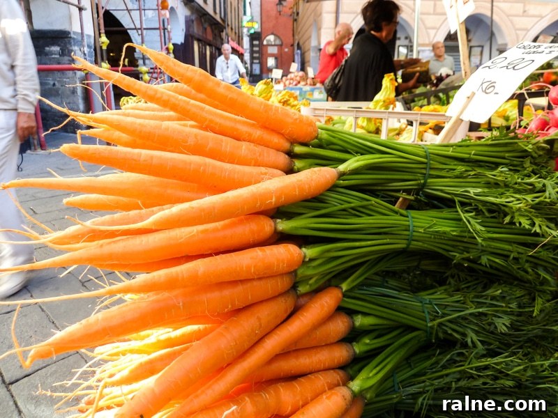 Honey-Ginger Glazed Carrots Recipe for Holiday Sides 3 Bunches of carrots with their greens still attached at a farmer's market in Italy.