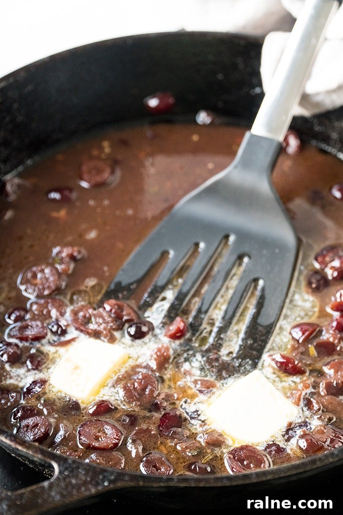 Port Wine and Cranberry Sauce been made in a skillet.